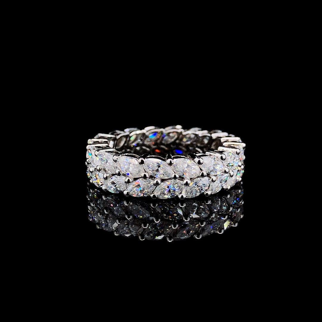 A sterling silver ring with two layers of marquise-cut moissanite stones on a black background.