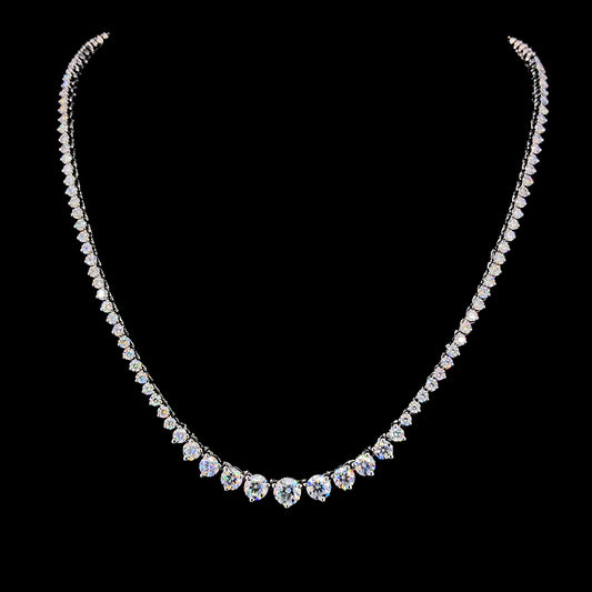 A sterling silver necklace with multiple round cut moissanite diamonds set along the length, presented against a black background.