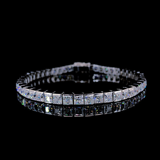 A tennis bracelet with princess-cut moissanite stones set in polished sterling silver.