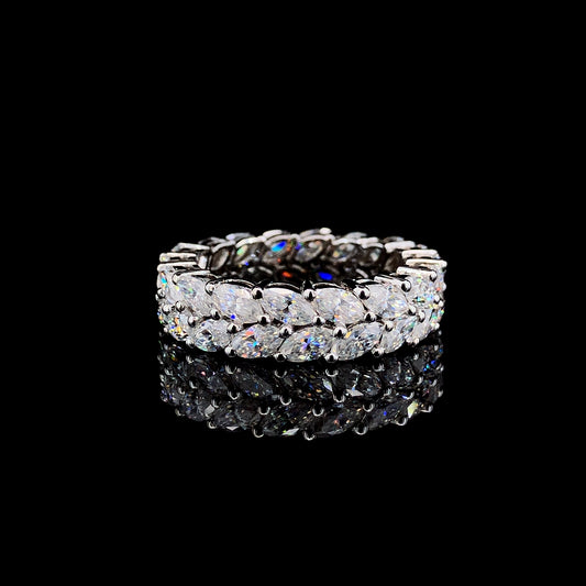 A sterling silver ring with two layers of marquise-cut moissanite stones on a black background.
